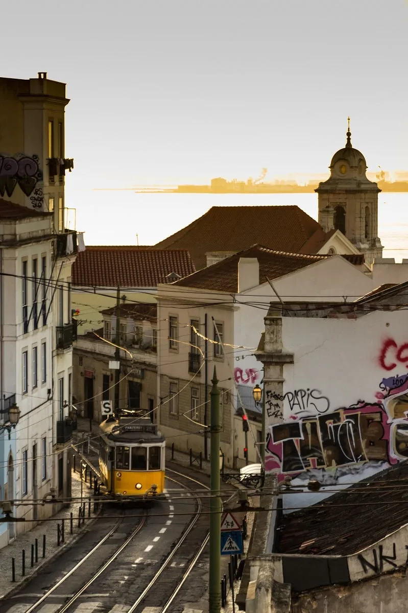 Un tramway dans une rue en pente aux couleurs du lever de soleil